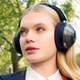 A user wearing the Dyson Zone headphones outside without the filtration visor attached.